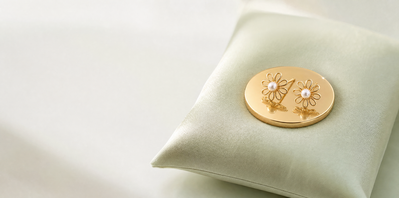 Earrings from Rs 1 - daisy studs resting on a gold coin