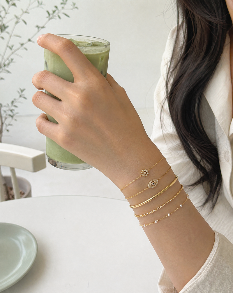 Build your own stack - stacked gold-tone bangles with matcha latte